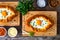 Georgian cuisine - khachapuri cheese-filled bread with fried egg on wooden background