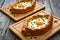 Georgian cuisine - khachapuri cheese-filled bread with fried egg on wooden background