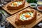 Georgian cuisine - khachapuri cheese-filled bread with fried egg on wooden background