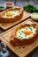 Georgian cuisine - khachapuri cheese-filled bread with fried egg on wooden background