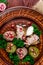 Georgian dish - phali of spinach and meat on a brown plate on a wooden background