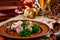 Georgian dish - phali of spinach and meat on a brown plate on a wooden background