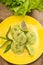 Georgian dumplings Khinkali of spinach dough with meat and tomato spicy sauce satsebeli. Wooden background. Top view. Close-up