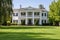 georgian house with dentil molding and manicured lawn in view