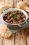 Georgian lobio recipe served with bread close-up in a pan. vertical