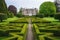 a georgian mansion with a perfectly manicured hedge maze
