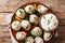 Georgian national dish khinkali dumplings with sour cream, pepper and herbs closeup on a plate. Horizontal top view