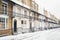 Georgian or Victorian style terrace houses other wise known as row houses in the snow in winter. They have ornate railings and