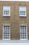 Georgian windows architecture on a wall house, London, UK