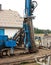 Geothermal drilling for house Heavy machine with drills next to newly constructed private house