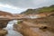 Geothermal fields of Krysuvik with river and mountains in the ba