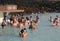 Geothermal spa visitors with silica mud masks relax and refresh at the famous Blue Lagoon