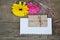 Gerberas floewrs with letter and white paper for your text on wood