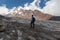 Gergeti Glacier - A man standing at the foothill of Gergeti Glacier, with the view on Mount Kazbeg, Caucasus