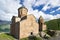 Gergeti Trinity Church, Tsminda Sameba on blue sky with clouds background in Georgia