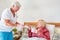 A geriatric nurse brings breakfast to a senior citizen`s bed