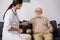 Geriatric nurse examining elderly man with