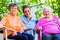 Geriatric nurse having chat with senior women