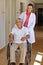 Geriatric nurse with senior man in wheelchair