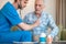 Geriatrician examining his patient with a stethoscope