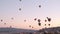 Gerime, Turkey - 09 10 2021: Timelapse of balloons at sunrise. Many balloonists at work, ride tourists in most touristic