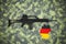 German  5.56 x 45mm assault rifleon camouflage background