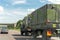 German armoured semi-trailer cargo truck carrier drives military convoy highway road. NATO troops moving reloceation