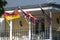 German, British and American flags waving in the wind on the old house