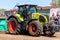 German claas axion tractor drives on track by a traktor pulling event