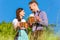 German couple in Tracht with beer, pretzel