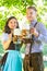 German couple in Tracht drinking beer