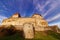 German Dark ages castle in soft sunlight by blue sky and Cirrus cloud