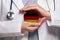 German doctor holding heart with flag of Germany background. Healthcare, charity, insurance and medicine concept