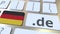 German domain .de and flag of Germany on the buttons on the computer keyboard. National internet related 3D rendering
