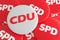 German Election Politics Badges Concept: Pile of SPD Buttons With CDU Button, 3d illustration