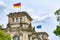 German and EU flags raising over Reichstag building Bundestag - parliament of Germany in Berlin