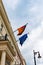 German and European Union flags waving from the German embassy balcony in London exterior view