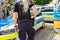 German female police officer stands in front of police cars