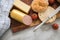 German fine veal liver sausage spread with crispy bread roll bun, butter, tomatoes and knife on wooden board, kitchen towel and