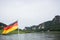 German flag at ferry through the Elbe at Kurort Rathen village and Bastei rocks