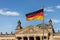 German Flag in front of the German Parliament Bundestag - Reichstag Building - Berlin, Germany