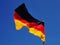 German Flag in gusty wind conditions under a blue sky