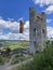 german flag next to a medieval remnant wall of a fortress and panoramic view of the Moselle valley below