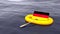 German flag swimming in a yellow rubber boat alone