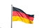 German flag waving on silver flagpole. White background, close up, space.