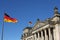 German flags and Reichstag building in Berlin, Germany