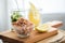 German Friesland north sea brown shrimps in glass bowl with cucumber salad and lemon on wooden board