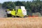 German havester Claas Lexion 650 works on a corn field