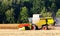 German havester works on a corn field