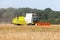 German havester works on a corn field